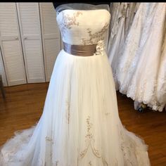 a white wedding dress on display in a store