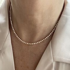 "This classic necklace is made from high quality genuine AAA grade 4.5mm semi-round round pink all natural fine freshwater pearls with peach undertones, with a high luster. A delicate, feminine & classy necklace perfect for all occasions and bridal too. These pearls have a rich luster, are perfectly calibrated, and are uniform in size.  Pearls have an international grading scale, these beautiful pearls are graded as follows: surface: AAA luster: AAA round: AA+ - Photos taken outside in natural l Dainty Single Strand Akoya Pearl Necklace, Dainty Akoya Pearl Single Strand Necklace, Pink Akoya Pearl Necklaces With Round Beads, Pink Single Strand Akoya Pearl Necklace, Pink Akoya Pearl Round Bead Necklace, Pink Akoya Pearl Single Strand Necklace, Dainty Single Strand Round Pearl Necklace, Pink Akoya Pearl Necklace With Round Beads, Classic Rose Gold Necklaces With Round Beads