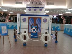 an inflatable boat and life preserver are on display at the mall's entrance