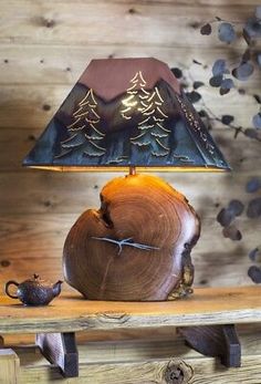 a wooden table with a lamp on top of it and a teapot next to it