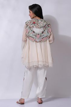 Ivory white floral embroidered jacket. Paired with an inner and embroidered pant.
Components: 3
Pattern: Embroidered
Type Of Work: Chikankari
Neckline: V Neck
Sleeve Type: Flared
Fabric: 25% Silk, 75% Cotton
Color: Ivory,White
Other Details: 
Attached cotton lining
Model Height: 5 ft 7 inches, wearing size M
Closure: Zip
Occasion: Resort - Aza Fashions White Dupatta For Designer Wear In Spring, Designer White Dupatta For Spring, Spring Designer White Dupatta, White Georgette Dupatta For Spring, White Dupatta With Embroidered Border For Spring, Spring White Dupatta With Embroidered Border, Spring Off White Sets With Embroidered Border, Embroidered Off White Georgette Sets, Cream Georgette Sets With Floral Embroidery