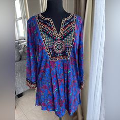 Great Quality Blue Embroidered Top With Floral Embroidery For Festivals, Blue Bohemian Tops With Embroidered Neckline, Bohemian Blue Tops With Embroidered Neckline, Blue Floral Embroidered Blouse For Festivals, Traditional Blue Blouse For Vacation, Blue Bohemian Embroidered Top For Vacation, Embroidered Blue Blouse For Vacation, Blue Long Sleeve Top With Embroidered Neckline, Blue Floral Embroidered Top For Festival