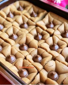 a pan filled with cookies and chocolates on top of a table