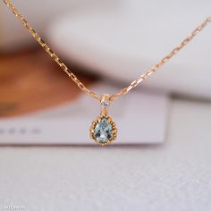 Embrace the serene beauty of our Teardrop Aquamarine Necklace, featuring a tiny aquamarine pendant. This elegant blue stone necklace showcases a teardrop-shaped aquamarine, a gemstone known for its calming energy and clarity. As the birthstone for March, aquamarine is a perfect gift for those born in this month. This necklace is a versatile accessory, ideal for both everyday wear and special occasions. Whether you're celebrating a March baby or looking for a thoughtful gift for her, this necklac Fine Jewelry Aquamarine Light Blue Necklace, Fine Jewelry Light Blue Aquamarine Necklace, Light Blue Aquamarine Necklace Fine Jewelry, Elegant Light Blue Round Pendant Necklace, Fine Jewelry Light Blue Gemstone Necklace, Light Blue Aquamarine Gemstone Necklace, Delicate Blue Topaz Jewelry, Blue Topaz Birthstone Necklace With Oval Pendant, Blue Topaz Oval Pendant Necklace As Gift