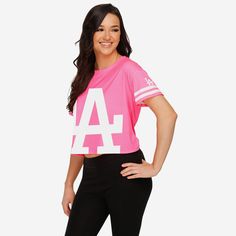 *SEP* *SEP* Add some crop top-tier style to your gameday attire. Your team spirit will stand out every time you rock this Los Angeles Dodgers Women's Highlights Crop Top! Features All-over bright, neon pink design so you can rep the team in style Bold team logo display, in case there were any doubts where your allegiances lie Miniature team logo display and stripe accents on sleeves for a little extra team spirit Crop top structure that will have you looking fashionable AND fan-tastic Short slee Pink Athleisure Top For Sports, Pink Crew Neck Activewear For Spring, Sporty Top With Team Logo For Sports Season, Collegiate Stretch Tops For Sports Events, Sporty Crop Top For College In Spring, Sports Fan Moisture-wicking Tops For Game Day, Moisture-wicking Tops For Game Day, Sports Fan Style, Varsity Tops For Spring Streetwear, Spring Sports Event Tops