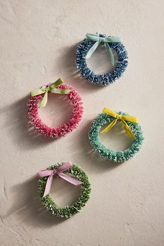 three different colored bracelets with bows on them