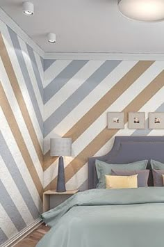 a bedroom with striped walls and blue bedding