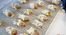 pastries on a cooling rack with powdered sugar