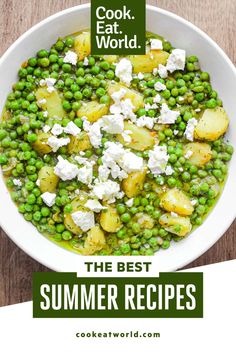 a bowl filled with peas, potatoes and feta cheese on top of a wooden table