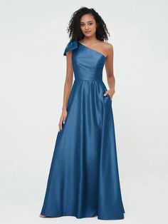 a woman in a long blue dress with one shoulder and an asymmetrical neckline