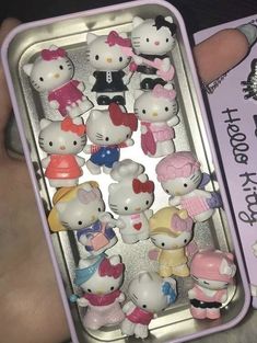 hello kitty toys are in a small tin