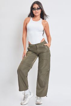 Comfort just got cuter. Meet our Women’s High Rise Nylon Cargo Pants With Bungee Hem - your new closet favorite. This high waisted parachute style pant is constructed with lightweight polyester for a nice airy feel and features decorative grommet detailing to add to the vintage military aesthetic. Fitted with an adjustable bungee tie at the hem so you can alter the look with a straight leg or cinched ankle depending on your mood. Style with a fitted rib tank and boots for an edgy look, or a body Nylon Cargo Pants, Military Aesthetic, Mood Style, Ymi Jeans, New Closet, Style Pant, Vintage Military, Olive Color, Edgy Look