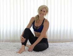 a woman sitting on top of a white rug