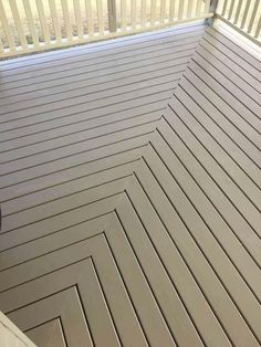 a deck that has been painted gray with white trim