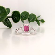 This beautiful ring features an emerald-cut ruby with a triad of natural earth-mined diamonds on both sides, all set in solid 14K white gold. This ring can be a lovely July birthstone gift for your loved ones! This ring is made with solid 14K Gold and naturally Earth-mined SI / G-H diamonds. If you're interested in purchasing this setting with a different center stone please message us! Fine Jewelry Ruby Ring With Radiant Cut Diamond, Emerald Cut Red Rings With Diamond Accents, Red Emerald Cut Rings With Diamond Accents, White Gold Emerald Cut Ruby Ring, Emerald Cut Ruby Ring With Diamond Accent Stones, White Gold Emerald Cut Ruby Diamond Ring, Emerald Cut Ruby Diamond Ring In White Gold, Heirloom Red Diamond Rings With Single Cut, Emerald Cut Ruby Ring With Accent Stones