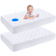 two baby mattresses sitting next to each other on top of each other with a blue object in the middle