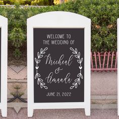 two white signs with wedding names on them