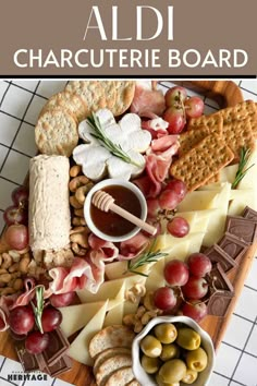 an assortment of cheeses, crackers and meats on a platter with the words aldi charcuterie board