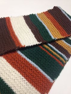 a multicolored crocheted tie laying on top of each other