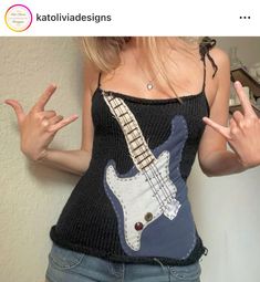 a woman wearing a black tank top with an electric guitar on it's chest