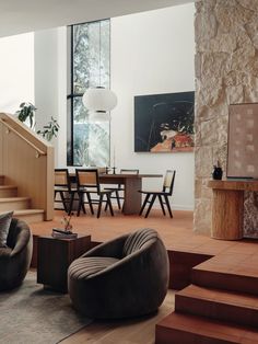 a living room filled with furniture and stairs