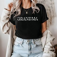 Custom Grandma T-shirt , Grandkids Name T-Shirt, Gift For Grannny T-shirt, Personalized Nana T-shirt,Mothers Day Gift,Best Grandmother Gift **Product Details** We exclusively utilize Bella Canvas and Gildan SoftStyle brands for our printing needs, renowned for their superior quality in the industry. *Bella Canvas - Available in unisex sizes - Weighing 4.2 oz. - Solid colors crafted from 100% Combed Cotton and Ring-Spun Cotton. - Athletic Heather composed of 90% Combed and Ring-Spun Cotton, 10% P Black Family Matching Tops With Funny Text, Black Tops With Letter Print For Family Matching, Mother's Day Graphic Tee With Text Print, Black Family Matching T-shirt With Name Print, Black T-shirt With Name Print For Family Matching, Black Tops With Letter Print For Mother's Day, Black Short Sleeve Top With Name Print, Black Graphic Print T-shirt For Mother's Day, Mother's Day Family Matching Crew Neck T-shirt