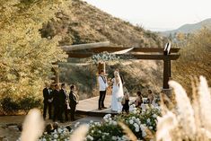 a bride and groom are getting married on a wooden platform