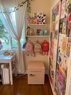 a room filled with lots of clutter and pictures on the wall next to a window