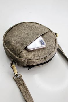 a cell phone in a bag on a white surface with a strap around it's waist