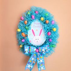 a blue wreath with an easter bunny on it