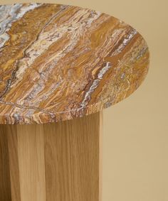 a close up of a wooden table with marble on it's top and bottom