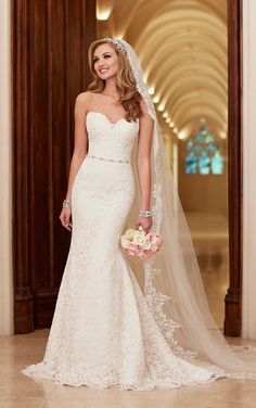 a woman in a wedding dress is posing for the camera