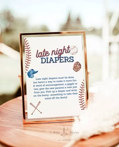 a sign that says late night diapers on top of a table with baseballs