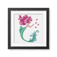 the little mermaid cross stitch pattern is displayed in a black frame on a white wall