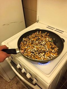 someone is frying some food in a pan on top of the stove and it looks like they are cooking