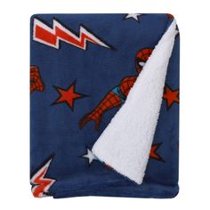 a blue blanket with spiderman on it and stars in the sky around it, as well as a white triangle