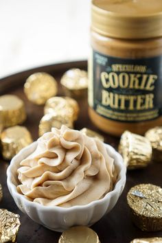 a bowl filled with some kind of food on top of a table next to gold foil