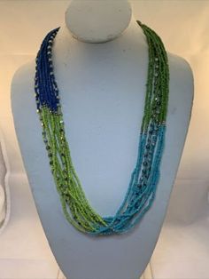 "Vintage 26\"-29\" 10 Strand Beaded Necklace. It is green, aqua blue and blue. It has a lobster clasp. It comes with a gift box. (Jewelry Tub 4 # 1820) USA Seller!! Estate sale find. We do not polish our estate treasures/vintage jewelry. Come Check out our Ebay store at Stores.ebay.com/gtnm1869. We also have vintage jewelry, Christmas ornaments, vintage glassware and many other items. We will combine shipping for multiple items if possible." Adjustable Blue-green Beaded Jewelry, Green Multi-strand Beads For Gifts, Multi-strand Green Large Beads, Handmade Blue-green Beaded Necklaces, Green Multi-strand Beaded Necklace As Gift, Green Multi-strand Beaded Necklace For Gift, Green Multi-strand Beaded Necklaces With Large Beads, Green Multi-strand Beaded Necklace With Large Beads, Blue-green Round Beads Jewelry For Gifts