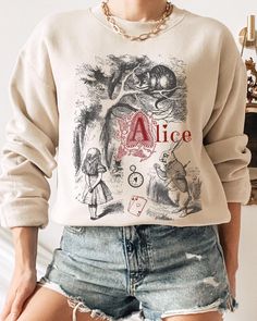 THE VINTAGE ALICE SWEATSHIRT We are super excited for you to get your hands on this new design Gildan sweatshirt. This product is very on trend and we hope you love it! 💜 If you would like to discuss any alternative size, color or product options, please do not hesitate to contact us directly. 💌 THIS DESIGN IS ALSO AVAILABLE AS A T-SHIRT: ➡️ ➡️ ➡️ https://www.etsy.com/uk/listing/1779881425/vintage-alice-alice-in-wonderland-shirt ✨ ABOUT OUR CREWNECK SWEATERS ✨ Our crewneck sweaters are pure co Themed Long Sleeve Tops With Graphic Print, Themed Long Sleeve Letter Print T-shirt, Themed Long Sleeve T-shirt With Letter Print, Vintage Sweatshirt With Cartoon Print, Themed Long Sleeve Tops With Letter Print, Alice Alice In Wonderland, Flat Lay Photos, Crewneck Sweaters, Gildan Sweatshirts