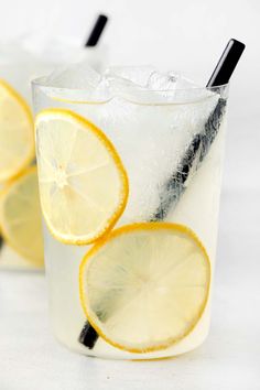 two glasses filled with lemonade and ice