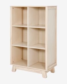 a white bookcase with four shelves on one side and two doors on the other