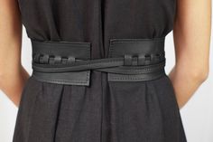 A quintessential classic from the yesteryears. This criss-cross belt is handmade using Italian cowhide and comes with contrasting running stitch lines for a vintage look. The wide strap is complemented with a slender second belt that can be tied at the front or side for a cinched silhouette. Add it as a finishing touch to your rompers, midi dresses, and T-shirts for a boho-inspired evening look. Dimensions: ● Measures 3" wide ● XS-26", S-29", M-32", L-35" length Material: The belt is made with t Formal Leather Corset Belt With Belt Loops, Black Leather Corset Belt With Belt Detail, Black Leather Corset Belt With Belt Loops, Cross Belt, Front Walk, Stitch Lines, Running Stitch, Wide Straps, Midi Dresses