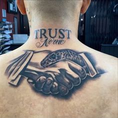 a man with a tattoo on his back that says trust more