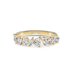 a yellow gold ring with five diamonds on it