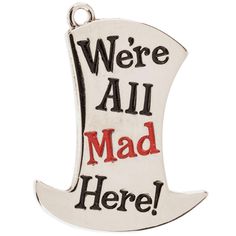 we're all mad here pendant in white and black with red lettering on it