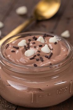 a chocolate dessert in a glass jar on a wooden table