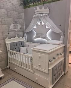 the baby crib has been decorated with white furniture and is next to a brick wall