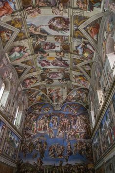 the ceiling is painted with many paintings