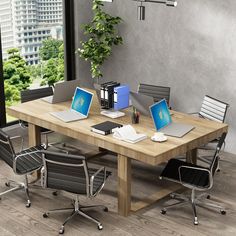 an office table with four laptops on it