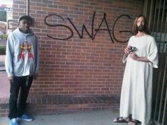 two men standing next to each other in front of a brick wall with the word swag written on it